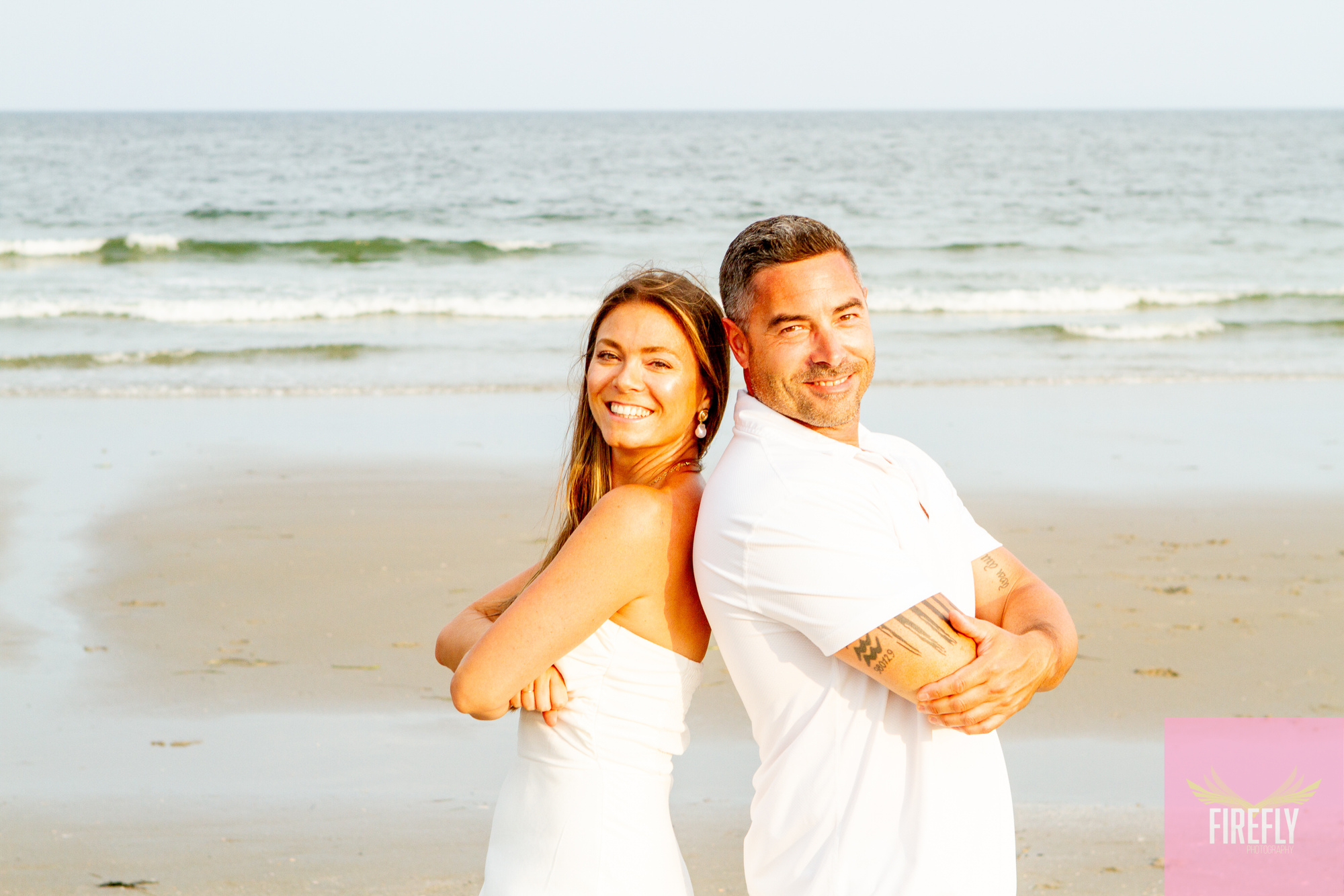 Couple back-to-back beach portrait at sunset
