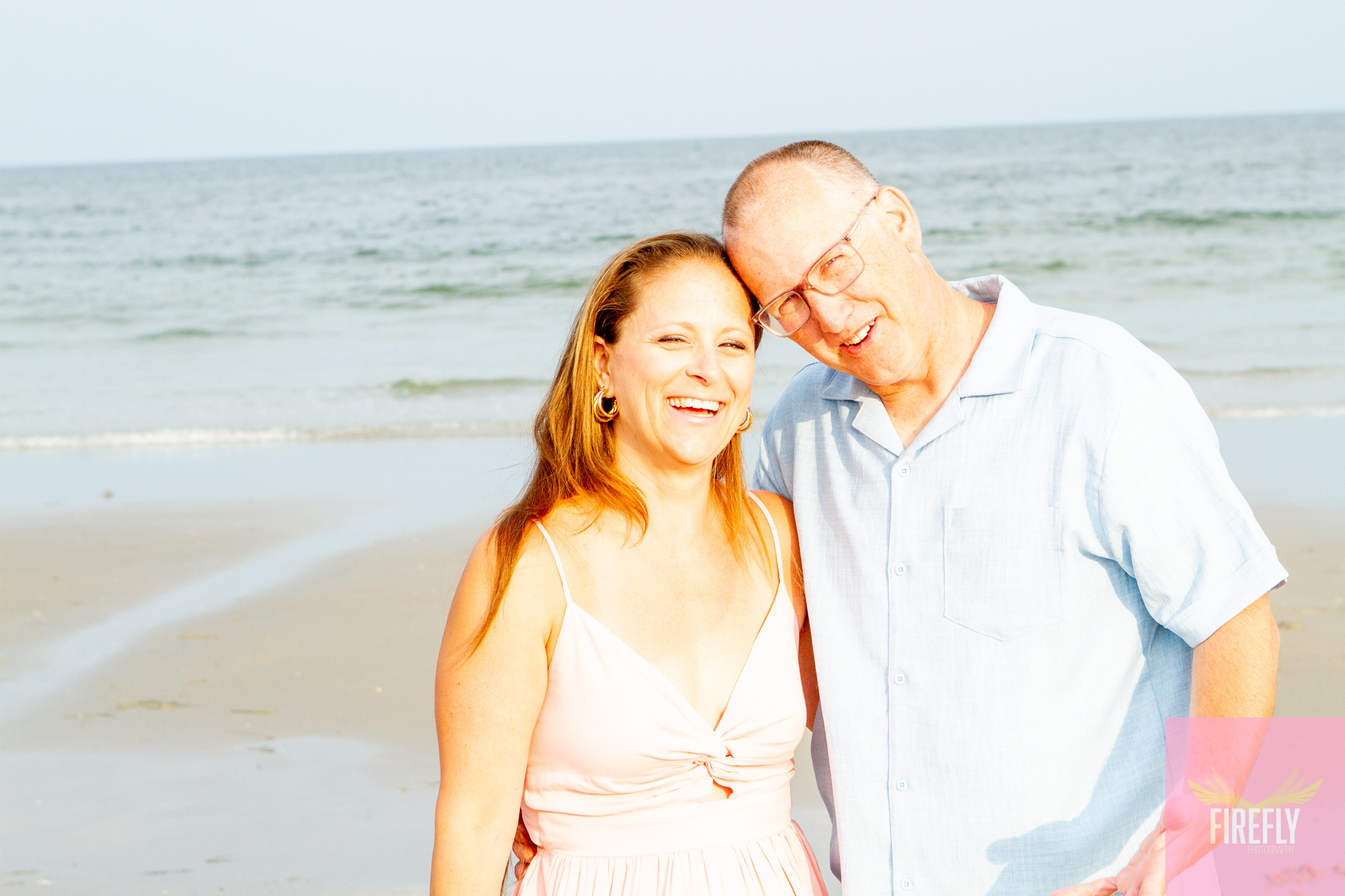 Romantic couple portrait at golden hour on the beach