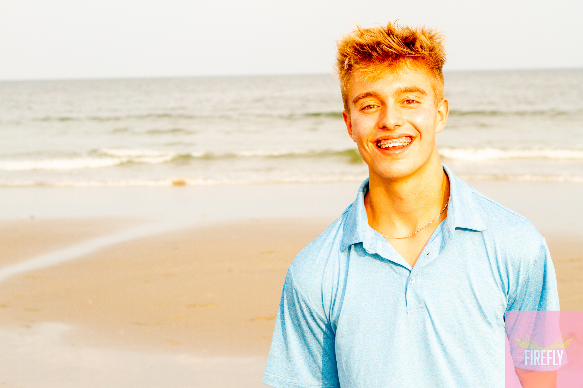 Senior portrait of a young man on the beach